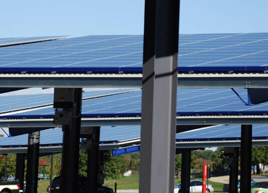 Solar panel structures provide shaded parking for vehicles