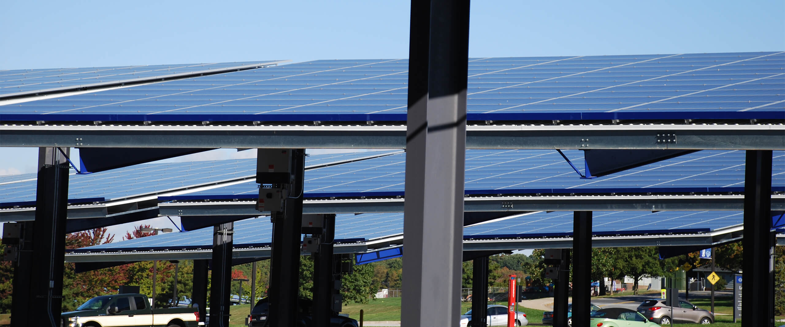 Solar panel structures provide shaded parking for vehicles