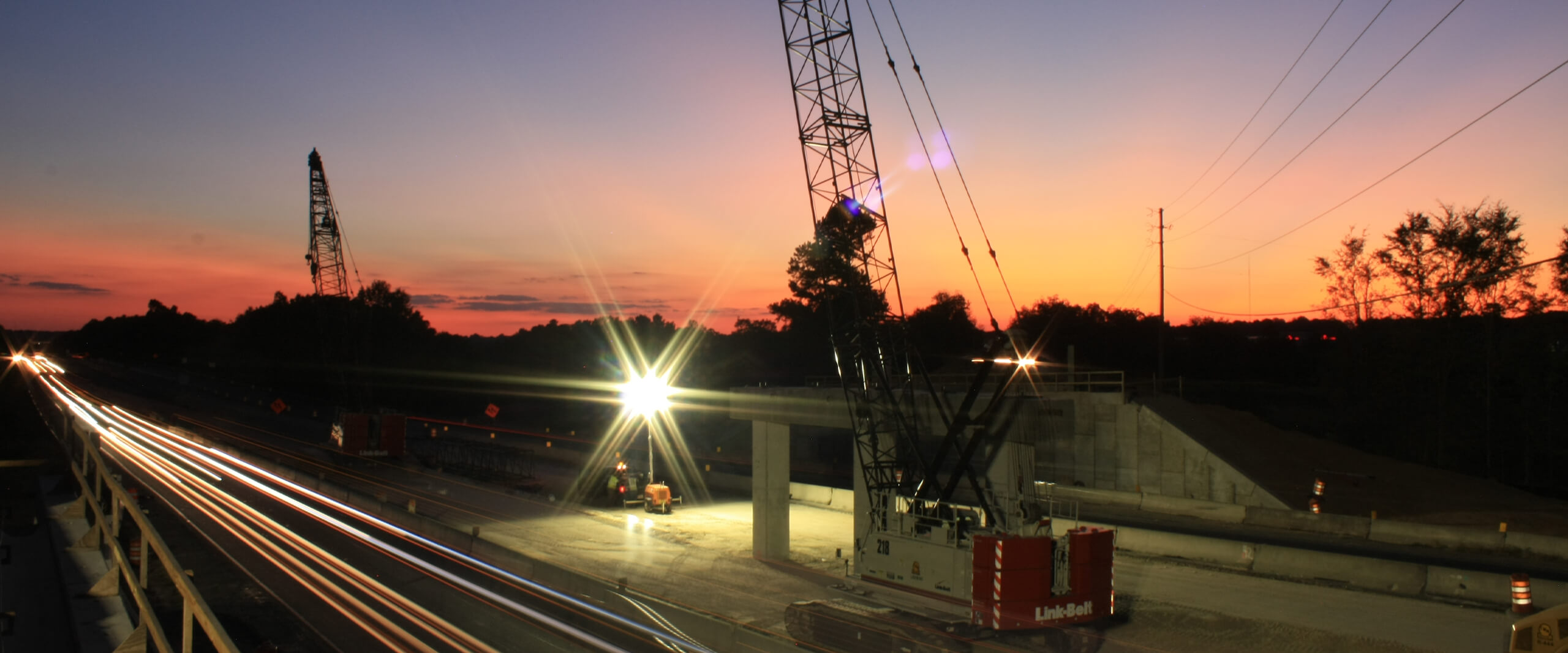 A nighttime shot of a crane performing structural inspection