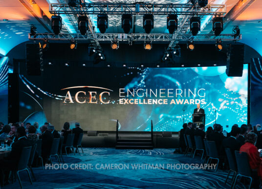 A stage with "ACEC Engineering Excellence Awards" text on the screen during the ACEC National Recognition Awards