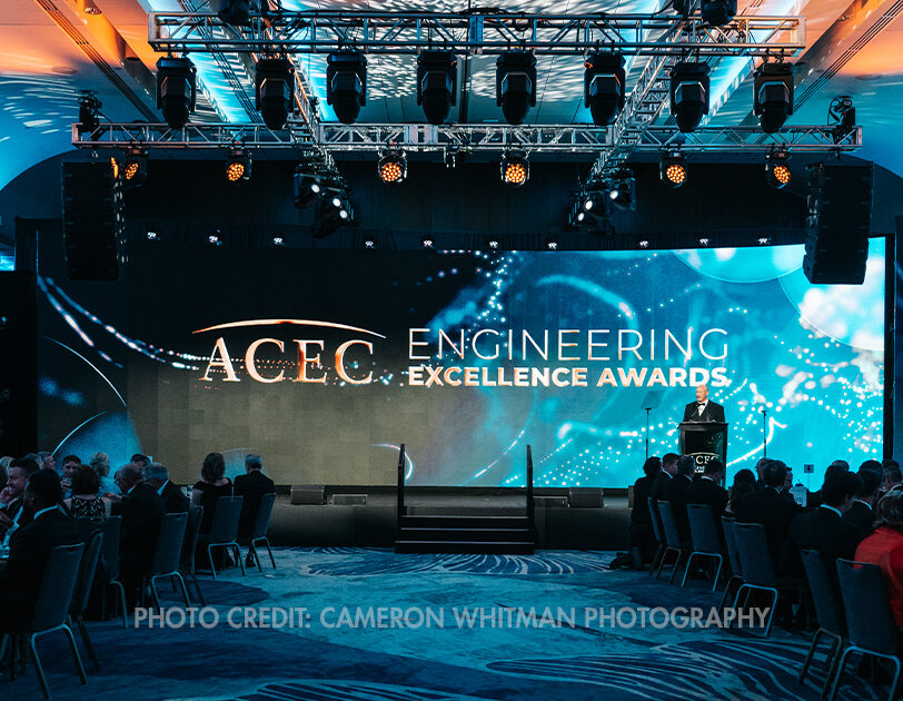 A stage with "ACEC Engineering Excellence Awards" text on the screen during the ACEC National Recognition Awards