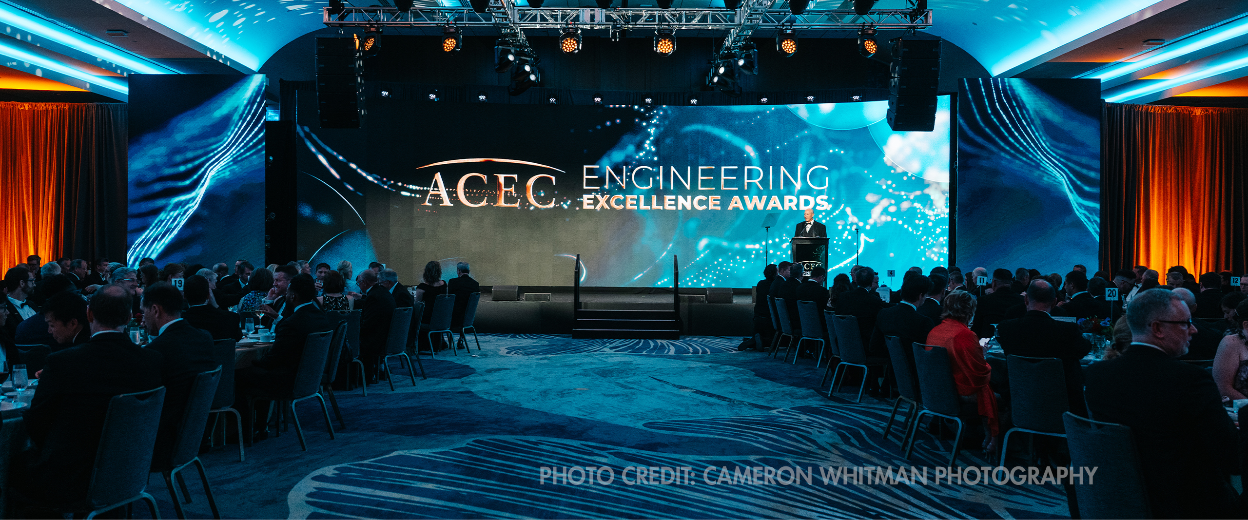 A stage with "ACEC Engineering Excellence Awards" text on the screen during the ACEC National Recognition Awards