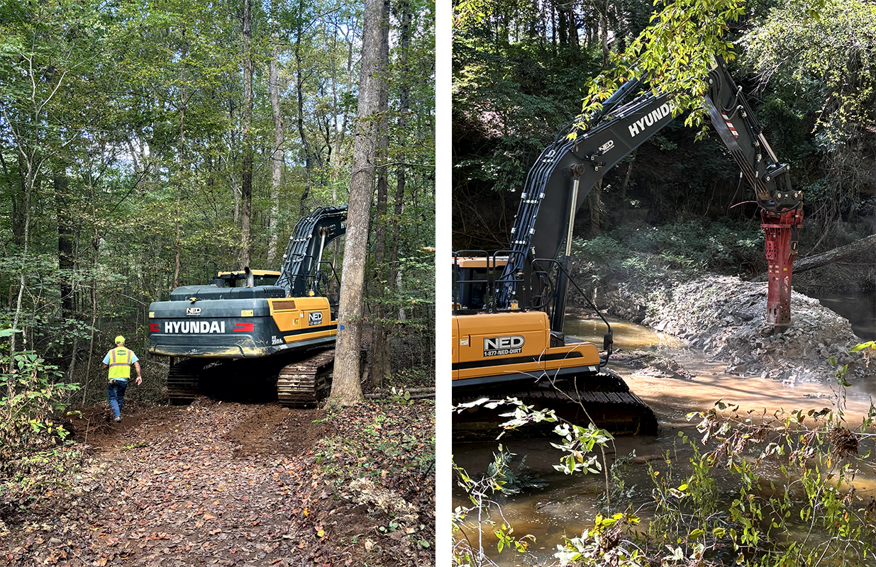 Worker guiding a tracked excavator along a narrow forest access route into the woods