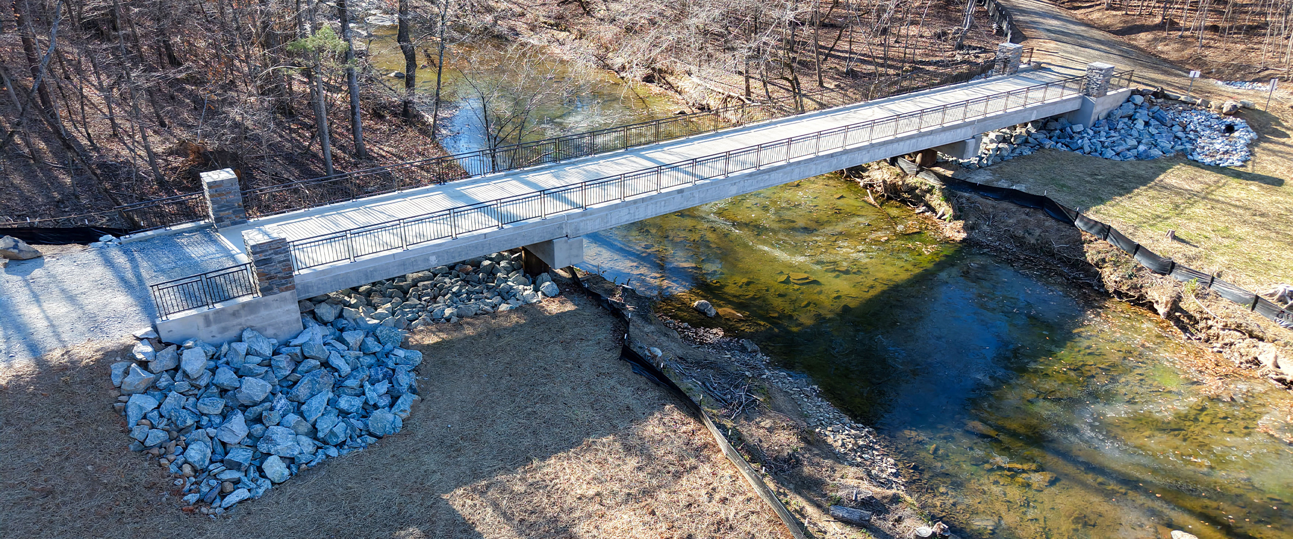 Aerial view of the new clear-span bridge over New Hope Creek in Duke Forest