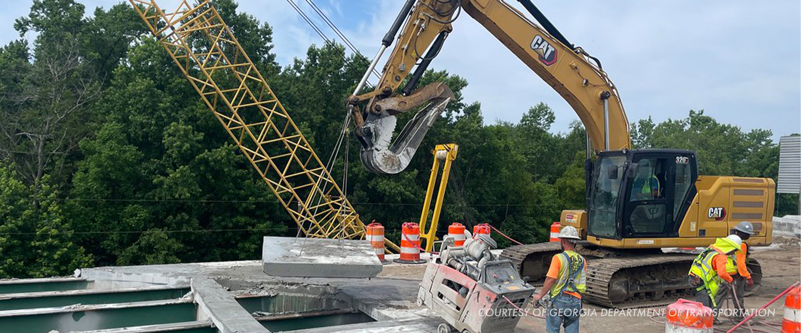 Crane and excavator working on a bridge deck at the I-16 at I-95 interchange in Savannah, Georgia