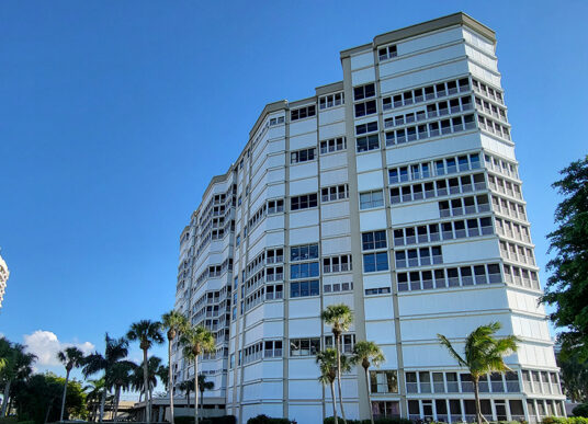 Monaco Beach Club condominium tower after facade restoration in Naples, Florida